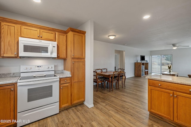 kitchen with ceiling fan, white appliances, and light wood-type flooring