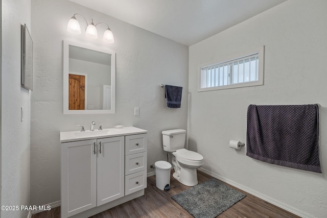 bathroom featuring vanity, toilet, and hardwood / wood-style floors