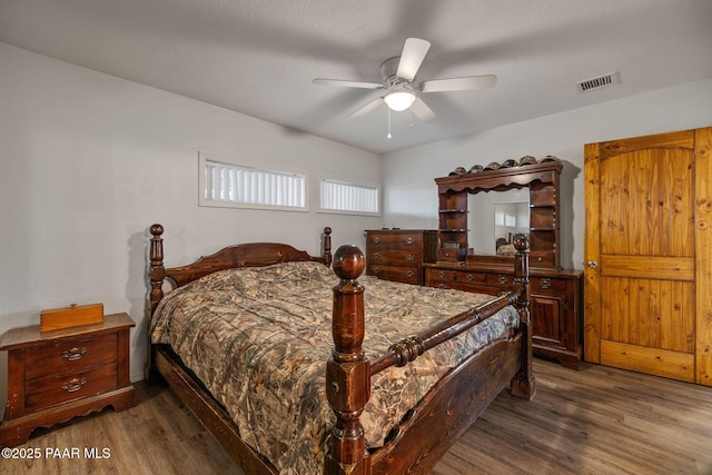 bedroom featuring ceiling fan and dark hardwood / wood-style floors