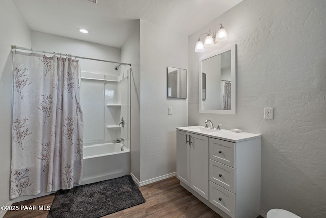 bathroom with hardwood / wood-style flooring, vanity, and shower / bath combination with curtain