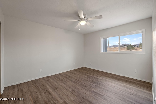 empty room featuring hardwood / wood-style flooring, a textured ceiling, and ceiling fan