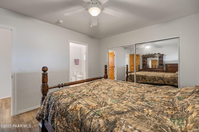 bedroom featuring ceiling fan, connected bathroom, light hardwood / wood-style floors, and a closet