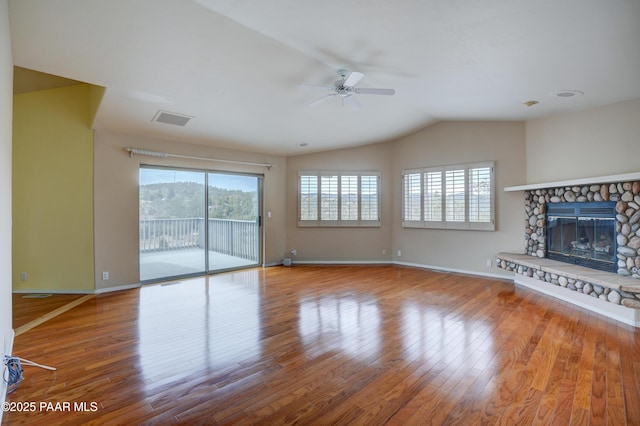 2312 Loma Vista Dr, Prescott, AZ 86305 - unfurnished living room with wood finished floors, a ceiling fan, visible vents, lofted ceiling, and a fireplace
