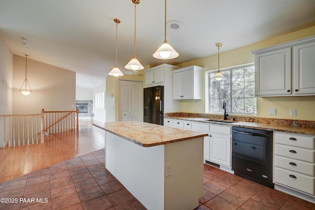 2312 Loma Vista Dr, Prescott, AZ 86305 - kitchen with a kitchen island, dark tile patterned floors, decorative light fixtures, black appliances, and a sink
