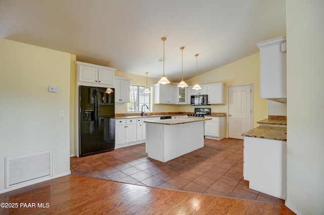 2312 Loma Vista Dr, Prescott, AZ 86305 - kitchen with visible vents, black appliances, a sink, a center island, and white cabinets