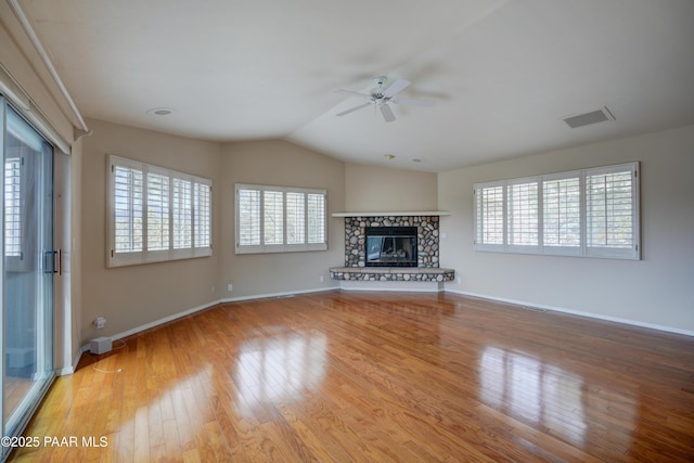 2312 Loma Vista Dr, Prescott, AZ 86305 - unfurnished living room with visible vents, wood finished floors, a stone fireplace, lofted ceiling, and ceiling fan