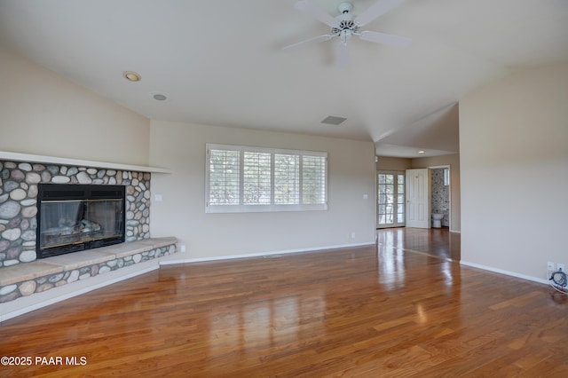 2312 Loma Vista Dr, Prescott, AZ 86305 - unfurnished living room featuring wood finished floors, baseboards, a ceiling fan, a stone fireplace, and vaulted ceiling