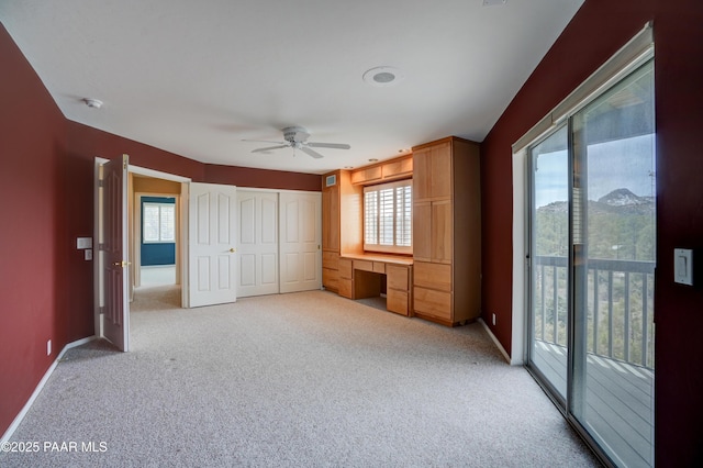 2312 Loma Vista Dr, Prescott, AZ 86305 - unfurnished bedroom with a ceiling fan, baseboards, built in study area, access to outside, and light colored carpet