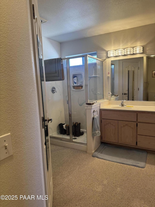 2350 W Gunsite Rd, Paulden, AZ 86334 - full bath featuring a textured wall, vanity, a shower stall, and a textured ceiling