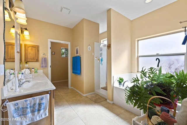 bathroom featuring tile patterned flooring, vanity, and shower with separate bathtub