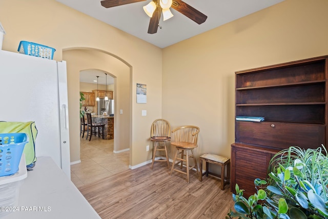 interior space with ceiling fan and light hardwood / wood-style flooring