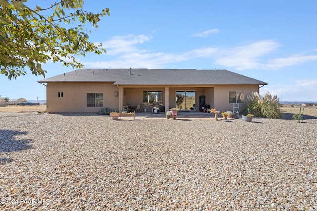 back of property featuring a patio