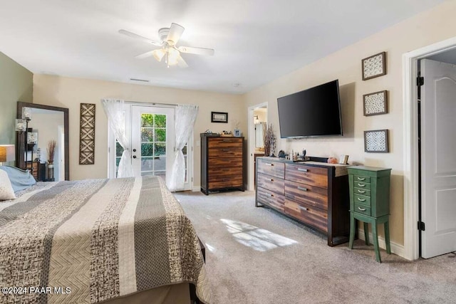 bedroom with access to exterior, light carpet, french doors, and ceiling fan