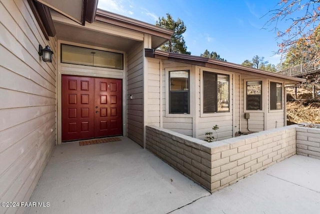 view of exterior entry featuring a patio area