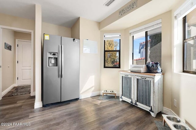 kitchen with radiator heating unit, dark wood-type flooring, and stainless steel refrigerator with ice dispenser