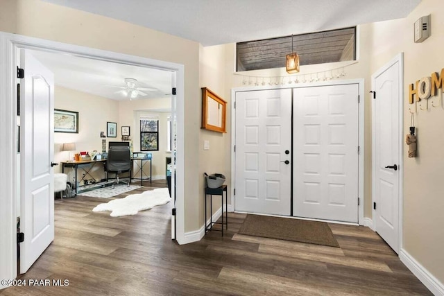 foyer entrance with dark hardwood / wood-style floors and ceiling fan