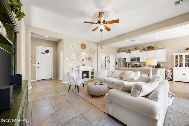 tiled living room with ceiling fan