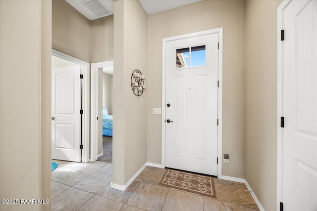 foyer entrance featuring light tile patterned flooring