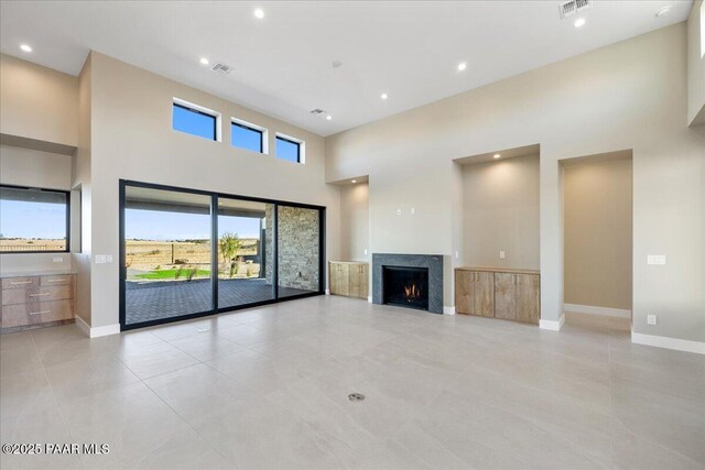 5285 High Cliff Way, Prescott, AZ 86301 - unfurnished living room featuring light tile patterned floors and a towering ceiling