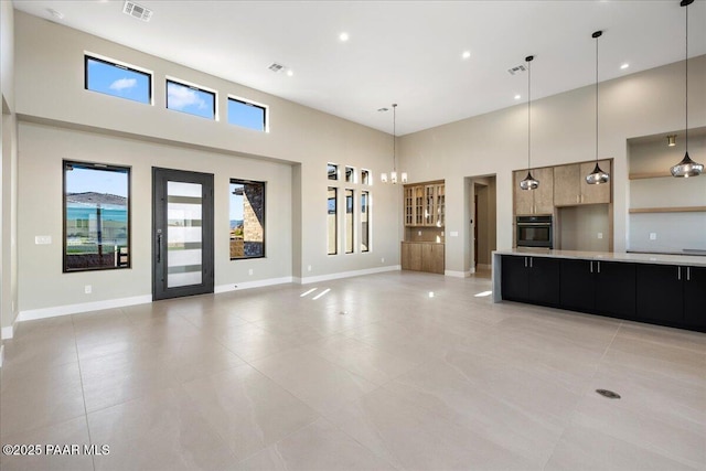 5285 High Cliff Way, Prescott, AZ 86301 - kitchen with a high ceiling, black oven, hanging light fixtures, and a chandelier