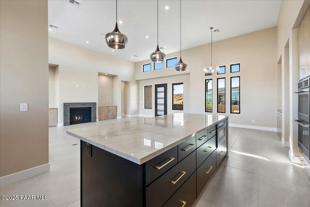 5285 High Cliff Way, Prescott, AZ 86301 - kitchen with light stone countertops, pendant lighting, french doors, a large island, and light tile patterned floors