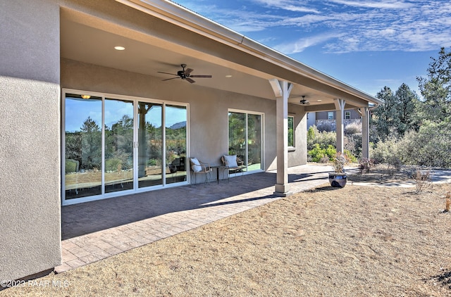 back of property with a patio area and ceiling fan