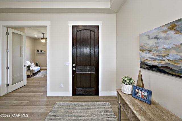 foyer entrance featuring light hardwood / wood-style floors and ceiling fan