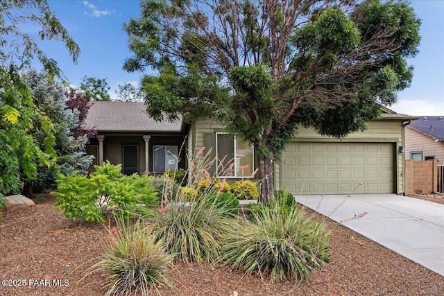 view of front facade with concrete driveway and an attached garage