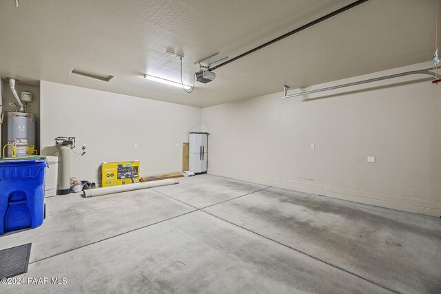 garage with a garage door opener and water heater