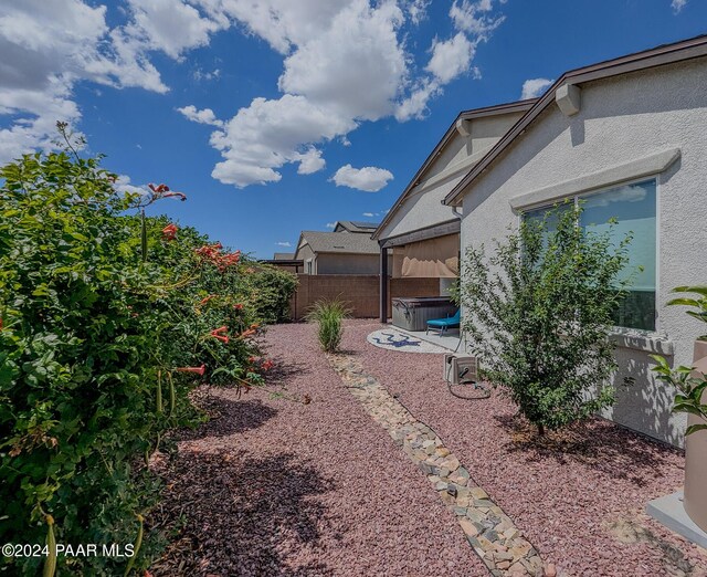 view of yard with a hot tub and a patio area