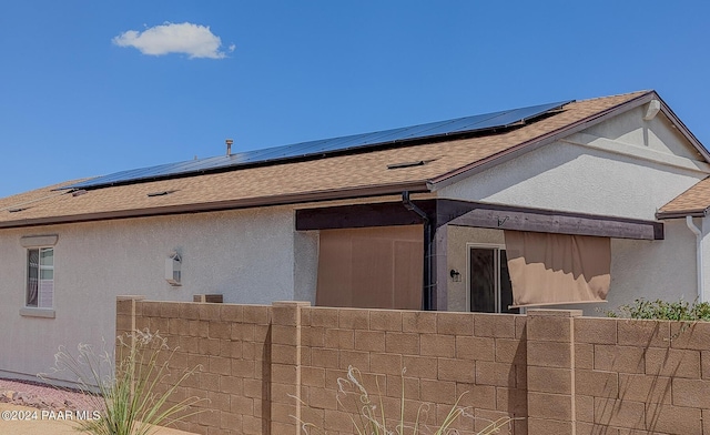 rear view of house with solar panels