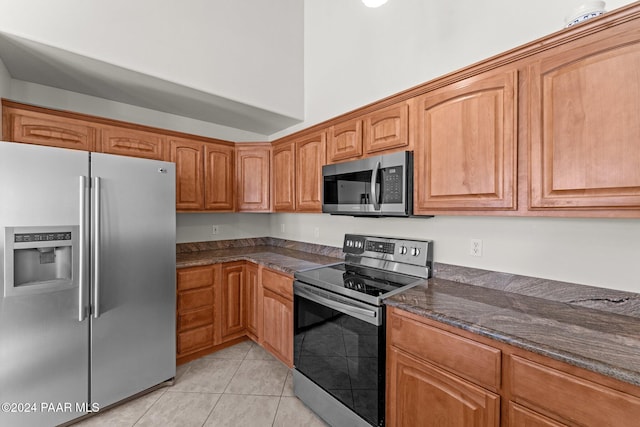 11645 E Prescott Dells Rnch Rd, Dewey-Humboldt, AZ 86327 - kitchen with appliances with stainless steel finishes, light tile patterned floors, and dark stone countertops