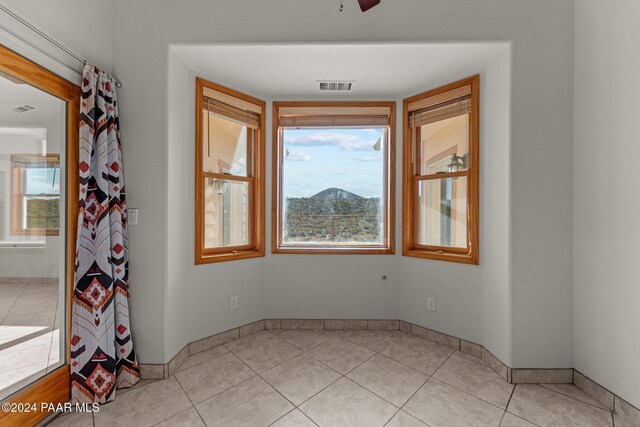 11645 E Prescott Dells Rnch Rd, Dewey-Humboldt, AZ 86327 - spare room featuring light tile patterned floors and ceiling fan