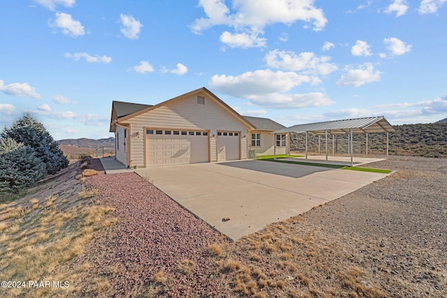 11645 E Prescott Dells Rnch Rd, Dewey-Humboldt, AZ 86327 - view of front facade featuring a carport, a mountain view, a garage, and an outbuilding