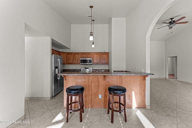 11645 E Prescott Dells Rnch Rd, Dewey-Humboldt, AZ 86327 - kitchen with appliances with stainless steel finishes, high vaulted ceiling, ceiling fan, and a breakfast bar area