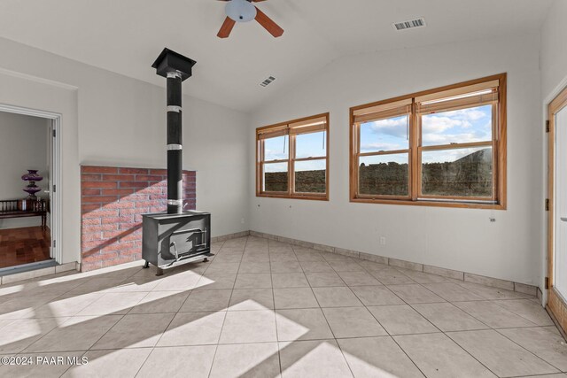 11645 E Prescott Dells Rnch Rd, Dewey-Humboldt, AZ 86327 - living room with lofted ceiling, ceiling fan, a wood stove, and light tile patterned floors