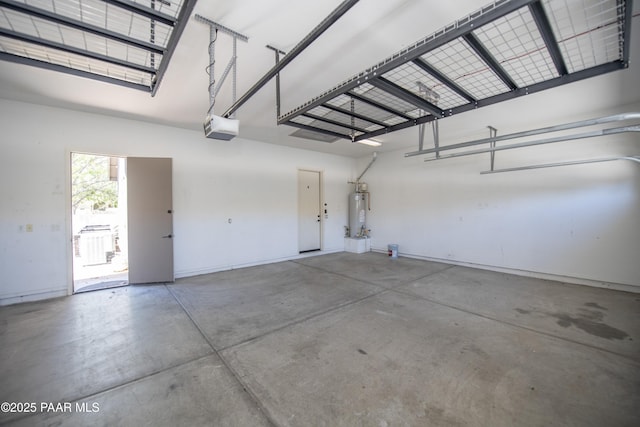 6560 E Brombil St, Prescott Valley, AZ 86314 - garage featuring water heater, a garage door opener, and baseboards