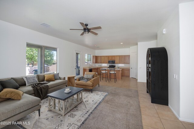 6560 E Brombil St, Prescott Valley, AZ 86314 - living area featuring light tile patterned floors, ceiling fan, and baseboards