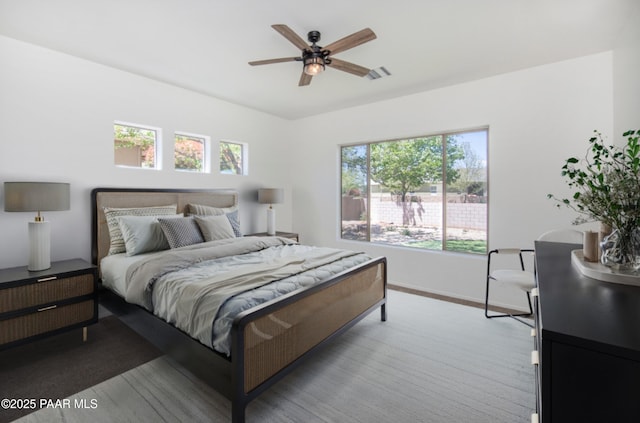 6560 E Brombil St, Prescott Valley, AZ 86314 - bedroom featuring multiple windows, baseboards, a ceiling fan, and light wood-style flooring