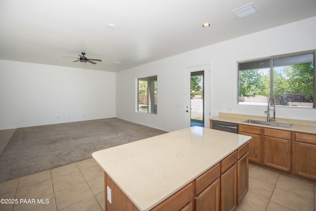 6560 E Brombil St, Prescott Valley, AZ 86314 - kitchen with a sink, light carpet, a kitchen island, light countertops, and a ceiling fan