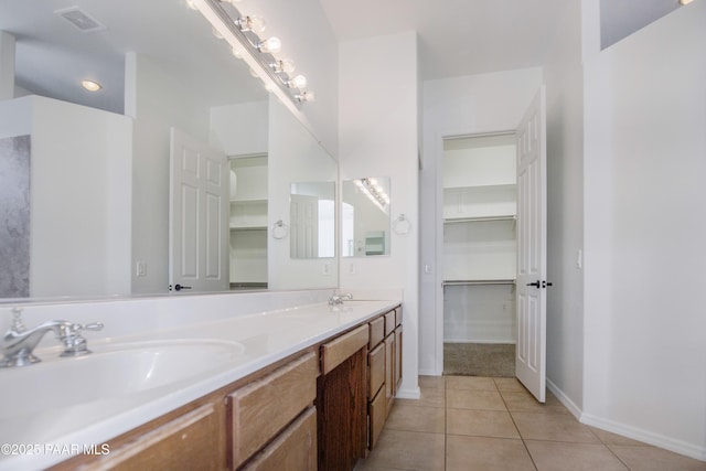 6560 E Brombil St, Prescott Valley, AZ 86314 - bathroom with tile patterned floors, baseboards, a walk in closet, and double vanity
