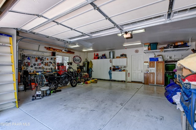 1021 Sheriffs Posse Trl, Prescott, AZ 86303 - garage featuring a garage door opener and a workshop area