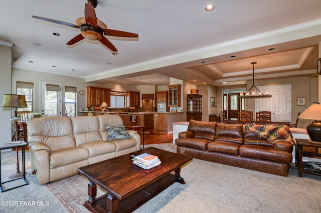 1021 Sheriffs Posse Trl, Prescott, AZ 86303 - living area with a ceiling fan, light colored carpet, ornamental molding, a chandelier, and a tray ceiling