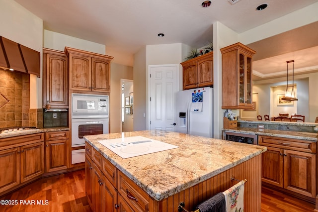 1021 Sheriffs Posse Trl, Prescott, AZ 86303 - kitchen featuring white appliances, brown cabinets, dark wood-style floors, glass insert cabinets, and a kitchen island