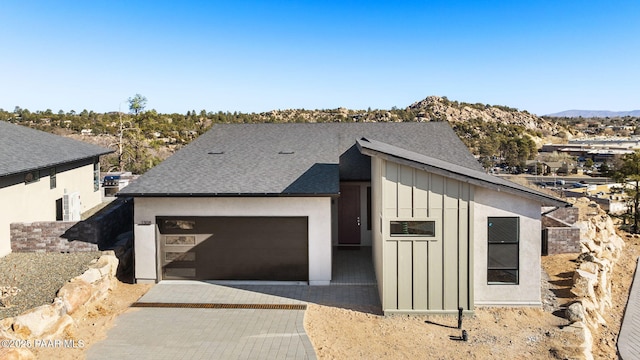 view of front facade featuring a mountain view and a garage