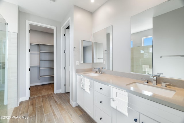 bathroom with walk in shower and vanity