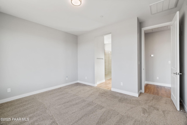 unfurnished bedroom with light colored carpet and ensuite bathroom