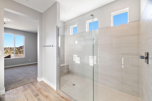 bathroom featuring a shower with door and hardwood / wood-style flooring