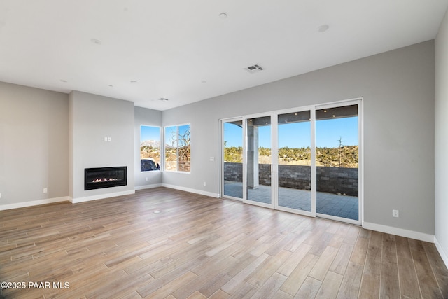 unfurnished living room with light wood-type flooring