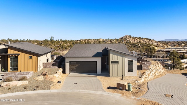 view of front of property featuring a mountain view and a garage